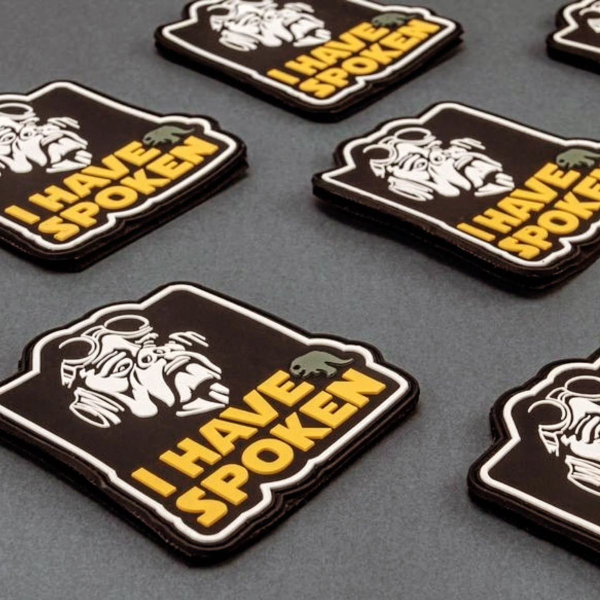 Custom embroidered patch with bold logo design on dark fabric background